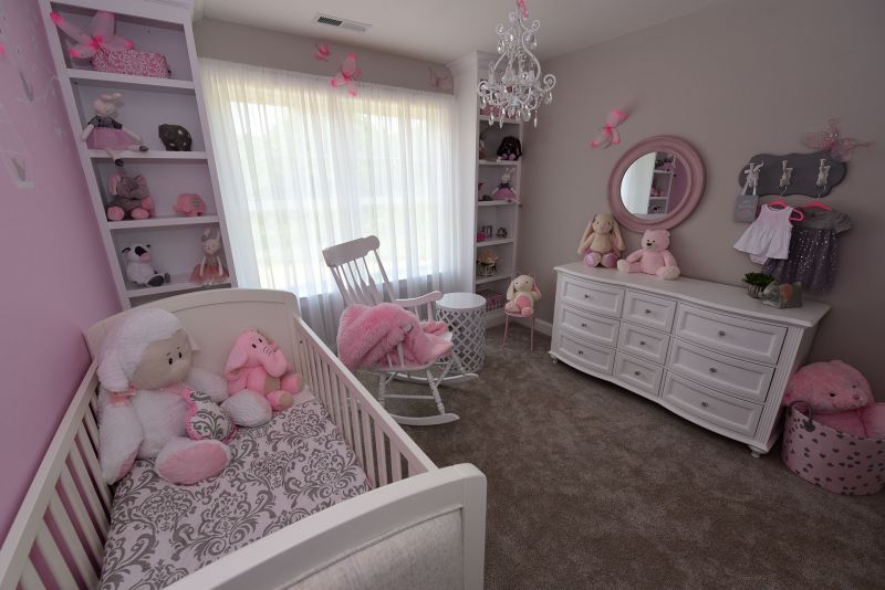 Image of back Bedroom fixed up as a nursery featuring custom built-in shelving around large window and wall to wall carpeting,